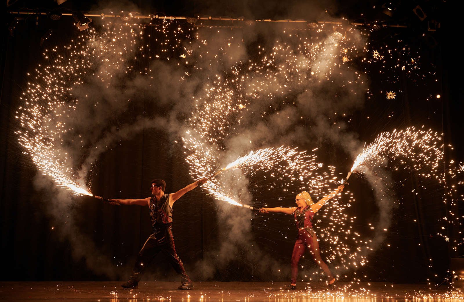 The finale of the Flashpoint Fire Show featuring two artists firing pyrotechnics in a huge circle around them.