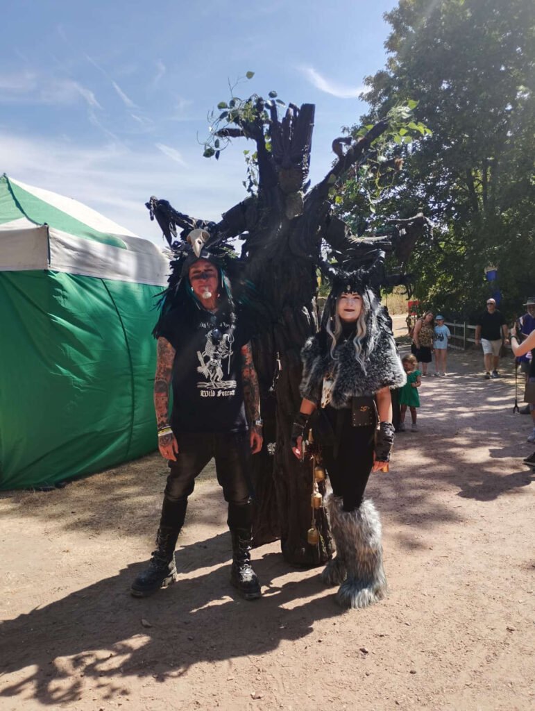 Two costumed guests stood with Megabeast Productions tree character
