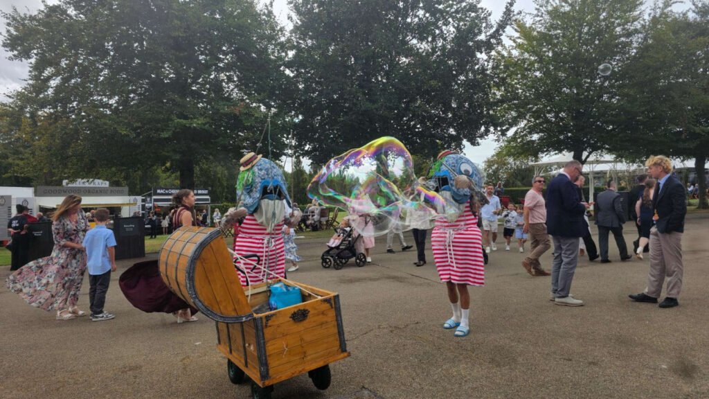 Performers with fishhead costumes making large bubbles