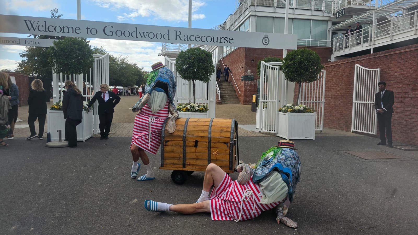 Two performers dressed as "reverse mermaids" stood at the entrance to Goodwood Racetrack